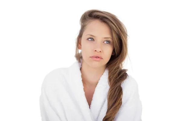 Wondering brunette in bathrobe looking away — Stock Photo, Image