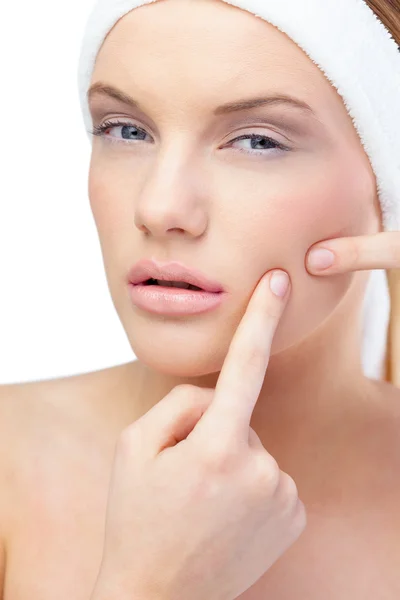 Blonde model pressing pimple on her cheek — Stock Photo, Image