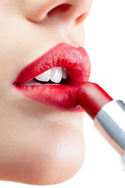 Extreme close up on gorgeous model applying red lipstick — Stock Photo, Image