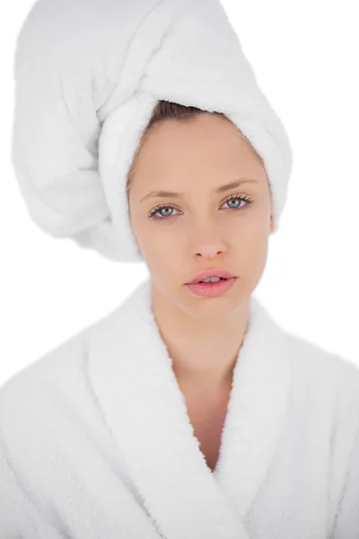 Thinking brunette in bathrobe looking at camera — Stock Photo, Image