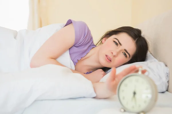Irritated girl waking up in her bed — Stock Photo, Image