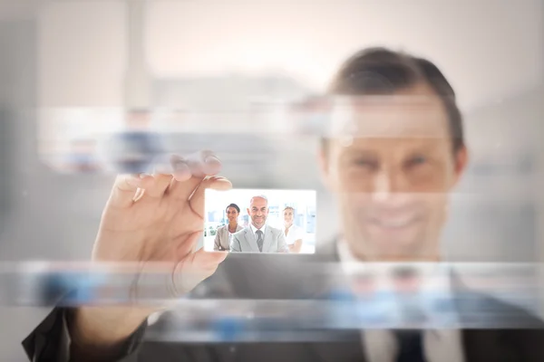 Pleased businessman presenting a picture of a business team — Stock Photo, Image