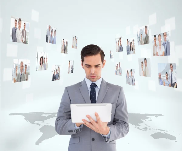 Businessman holding tablet encircled by digital interface — Stock Photo, Image