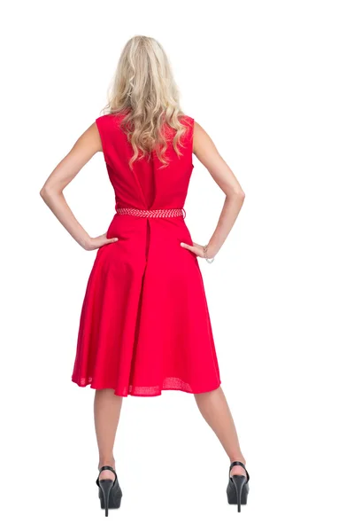 Rear view of gorgeous blonde in red dress posing — Stock Photo, Image