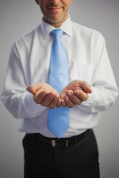 Close up of a pleased businessman joining his hands to the camera — Stock Photo, Image