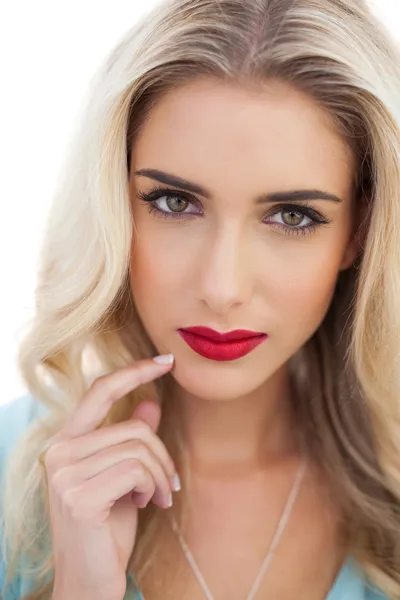 Portrait of a pensive blonde woman in blue dress looking at camera — Stock Photo, Image