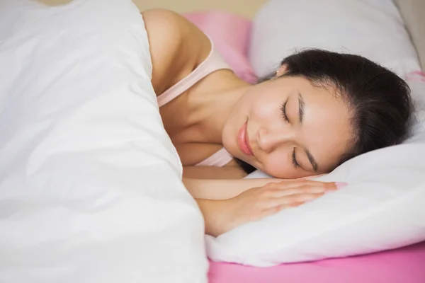 Peaceful young asian woman sleeping in her bed — Stock Photo, Image