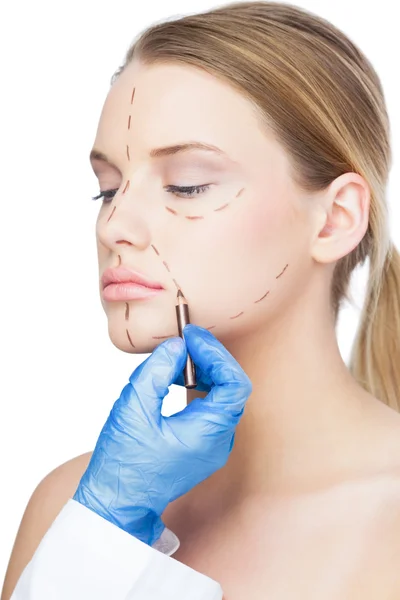 Surgeon drawing dotted lines on beautiful patient — Stock Photo, Image