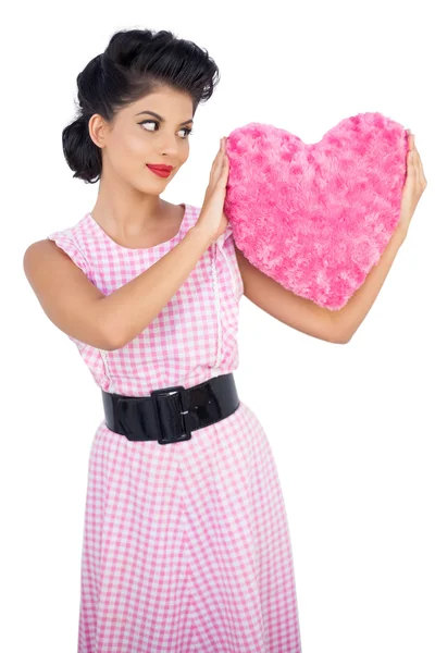 Stylish black hair model holding a pink heart shaped pillow — Stock Photo, Image