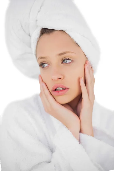 Anxious brunette in bathrobe looking away — Stock Photo, Image