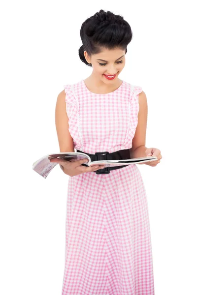 Pleased black hair model reading a magazine — Stock Photo, Image