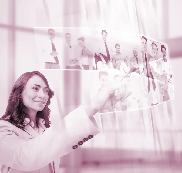 Pleased businesswoman scrolling pictures on digital screen — Stock Photo, Image