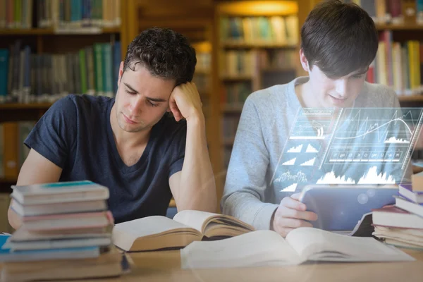 Focused students working together with futuristic interface — Stock Photo, Image