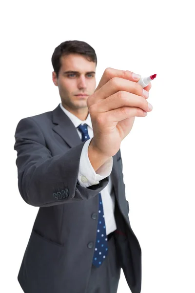 Concentrated businessman holding red marker Stock Picture