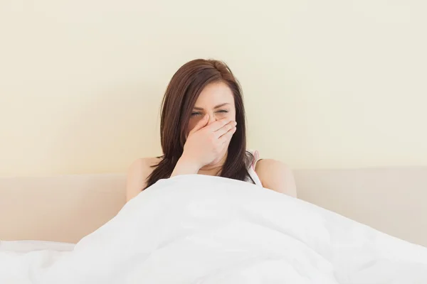 Awakened girl yawning in her bed Stock Picture