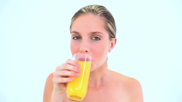 Blond woman holding a glass of orange juice — Stock Video