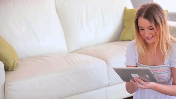 Encantadora joven rubia usando su tableta PC — Vídeo de stock