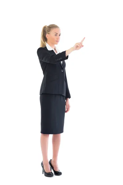 Side view of attractive blonde woman pointing — Stock Photo, Image