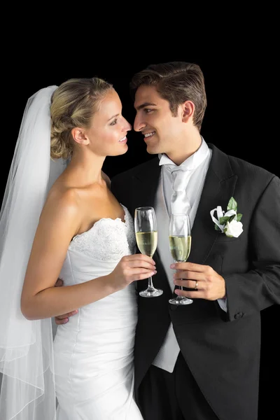 Gorgeous young married couple posing holding champagne glasses — Stock Photo, Image