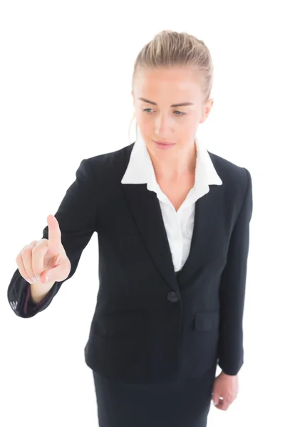 Smiling young business woman pointing — Stock Photo, Image