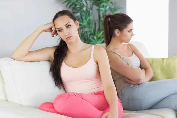 Two annoyed women sitting on a couch — Stock Photo, Image