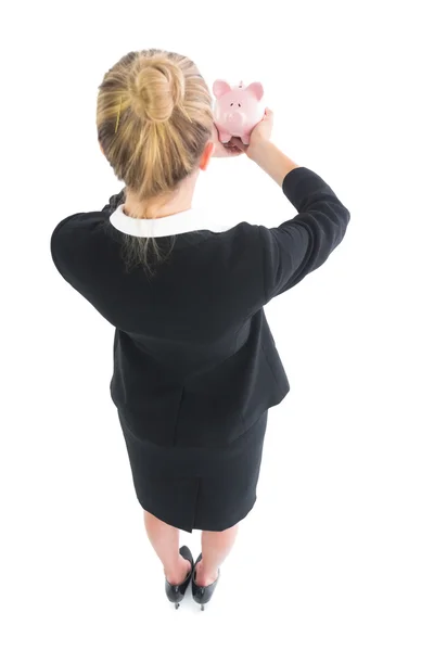 Young businesswoman showing a piggy bank — Stock Photo, Image