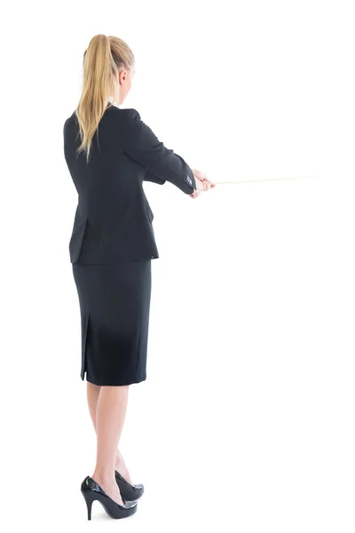 Rear view of standing business woman pulling a rope — Stock Photo, Image