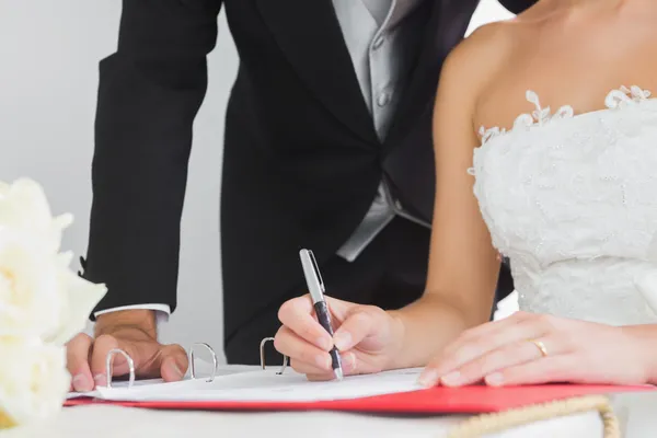 Close up of young bride signing wedding contract — Stock Photo, Image