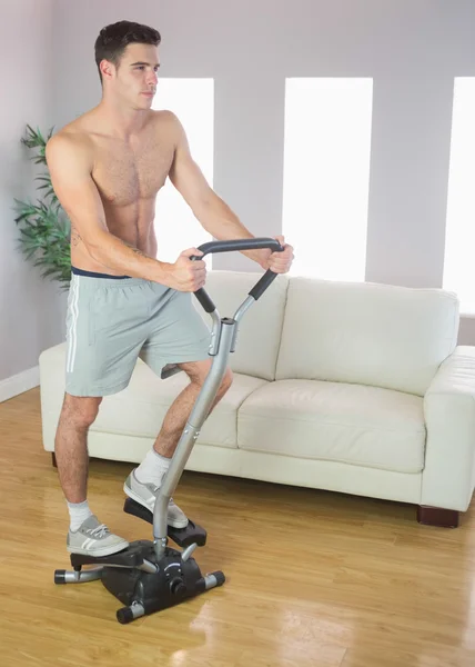 Serious handsome man training on stair climber — Stock Photo, Image