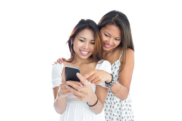 Two young sisters using smartphone — Stock Photo, Image
