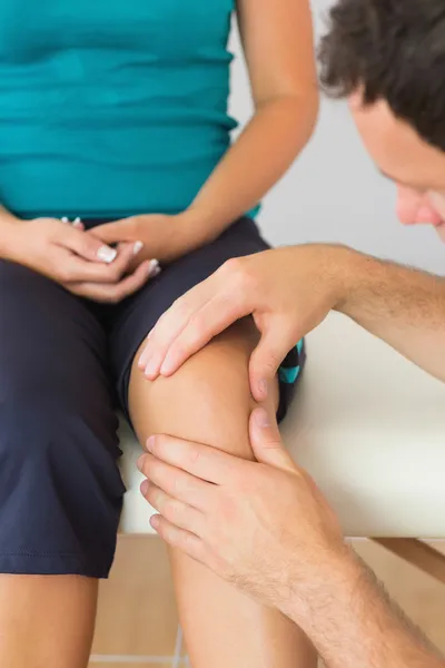 Fisioterapeuta examinando pacientes joelho — Fotografia de Stock