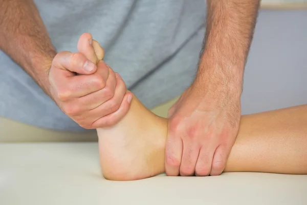 Physiotherapist examining patients foot — Stock Photo, Image