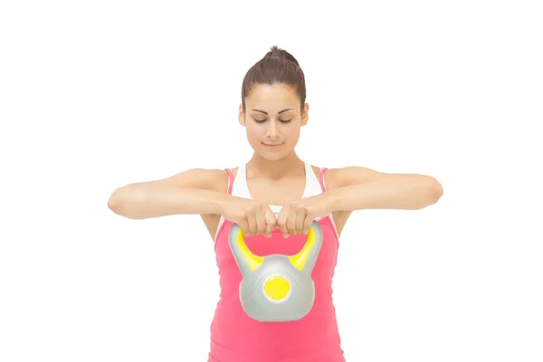 Contenuto bruna sportiva che tiene il kettlebell grigio e giallo — Foto Stock