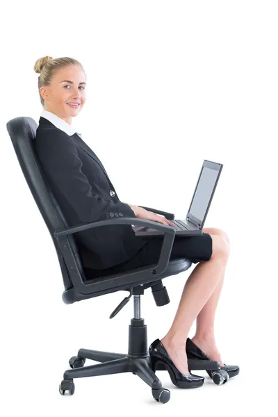 Side view of cute blonde businesswoman sitting on an office chair — Stock Photo, Image