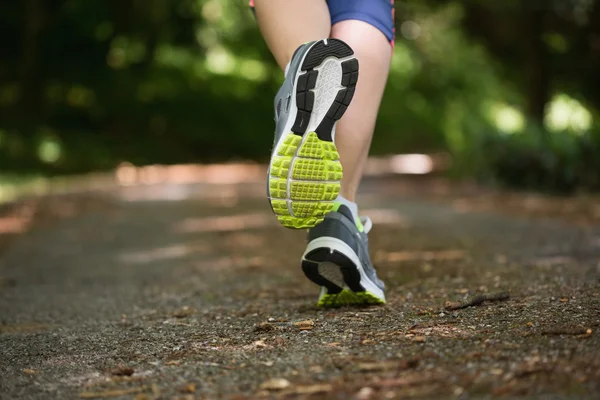 Woman jogging away from camera