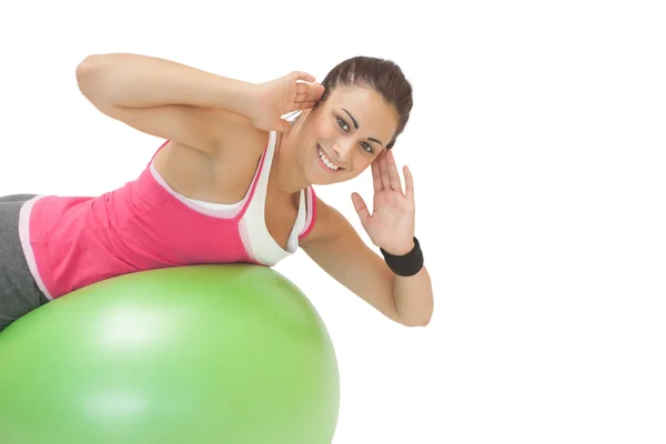 Cheerful sporty brunette doing exercise on exercise ball — Stock Photo, Image