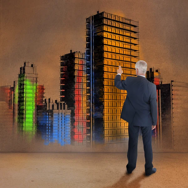 Rear view of businessman touching colorful city — Stock Photo, Image
