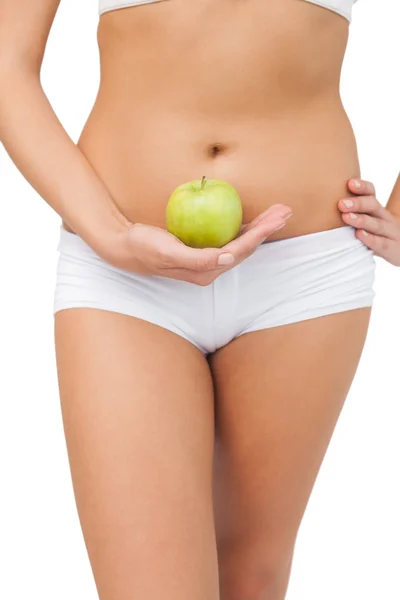 Close up of slim woman holding a green apple — Stock Photo, Image