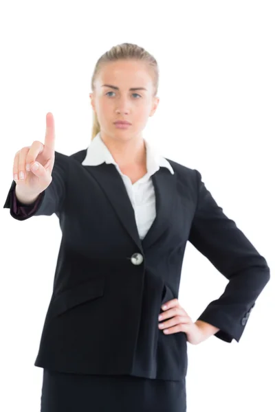 Focused young business woman pointing upwards — Stock Photo, Image