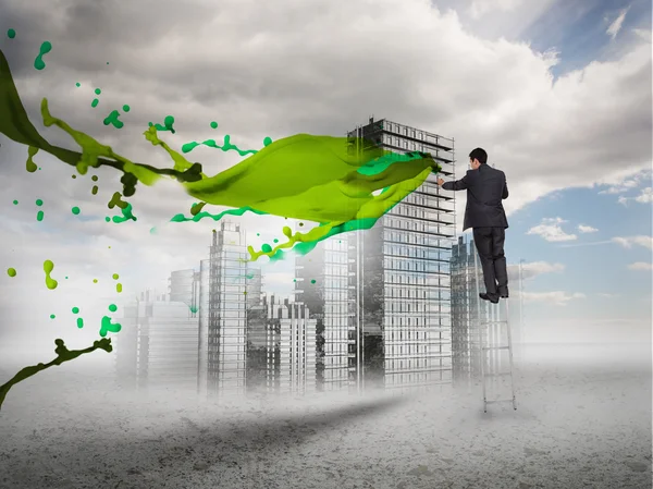 Achteraanzicht van zakenman aanraken holografische stad met groene splash — Stockfoto