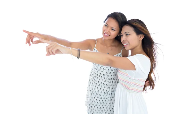 Two pretty young asian women pointing — Stock Photo, Image