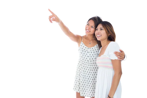 Cute asian women showing something to her sister — Stock Photo, Image