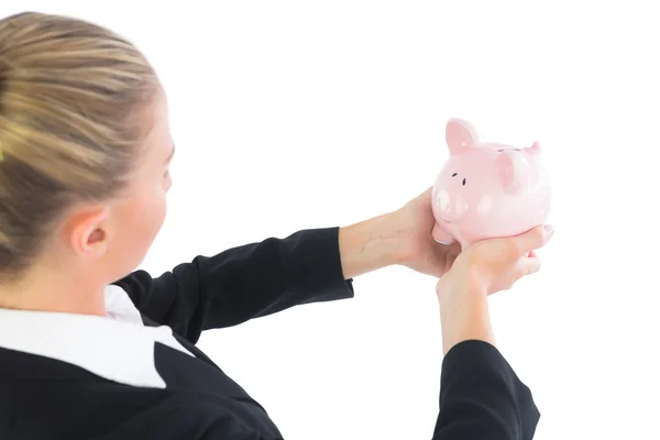 Blonde cute zakenvrouw houden een piggy bank — Stockfoto