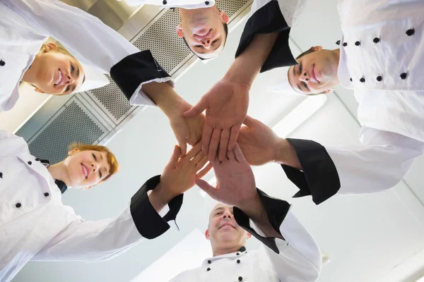 Chefs joining hands in a circle — Stock Photo, Image