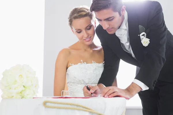 Handsome bridegroom signing wedding contract — Stock Photo, Image