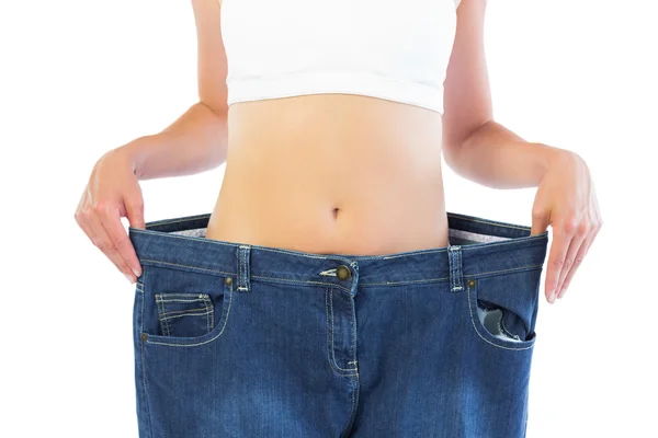 Close up of confident thin blonde wearing too big trousers — Stock Photo, Image