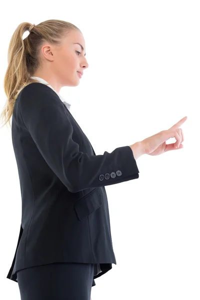Low angle side view of blonde businesswoman pointing upwards — Stock Photo, Image