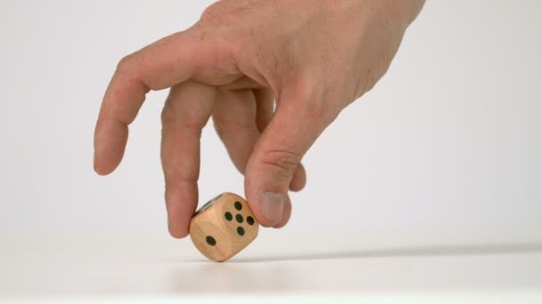 Hand letting twist a wooden dice — Stock Video