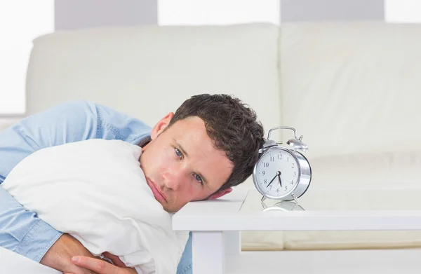 Troubled casual man resting head on table — Stock Photo, Image