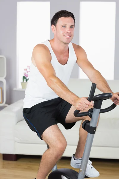 Sonriente deportista haciendo ejercicio en bicicleta — Foto de Stock